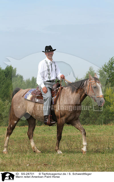Mann reitet American Paint Horse / SS-28701