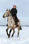 Frau reitet Appaloosa-Mix