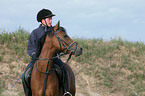 Frau reitet Deutsches Reitpony